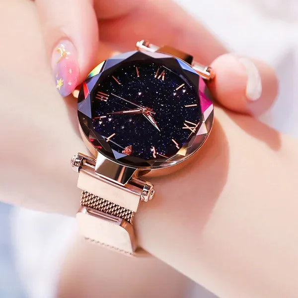 Relógio feminino rosa com mostrador estrelado e pulseira magnética.