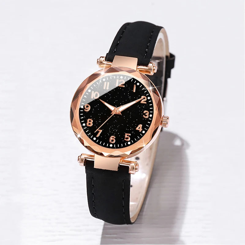 Relógio feminino céu estrelado preto com pulseiras douradas e pretas, elegante e moderno.