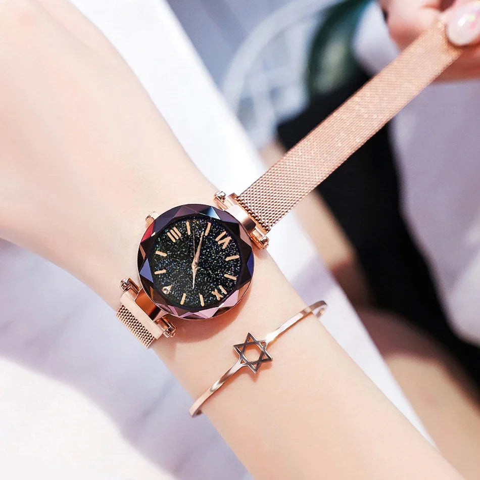 Relógio feminino rosa com mostrador estrelado e pulseira magnética.