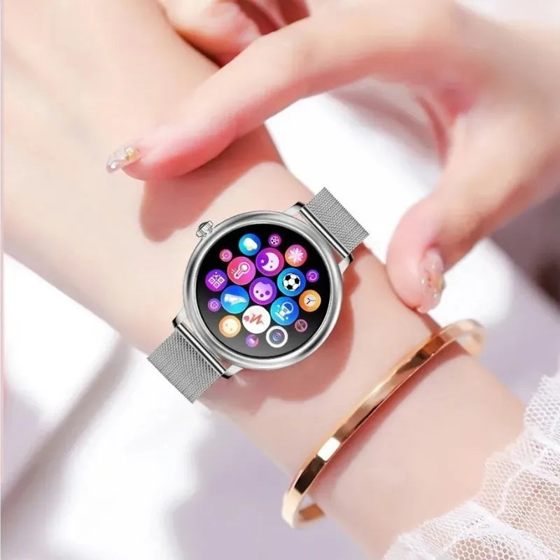 Smartwatch feminino prata com tela AMOLED, pulseira em aço fino e monitoramento de saúde completo.