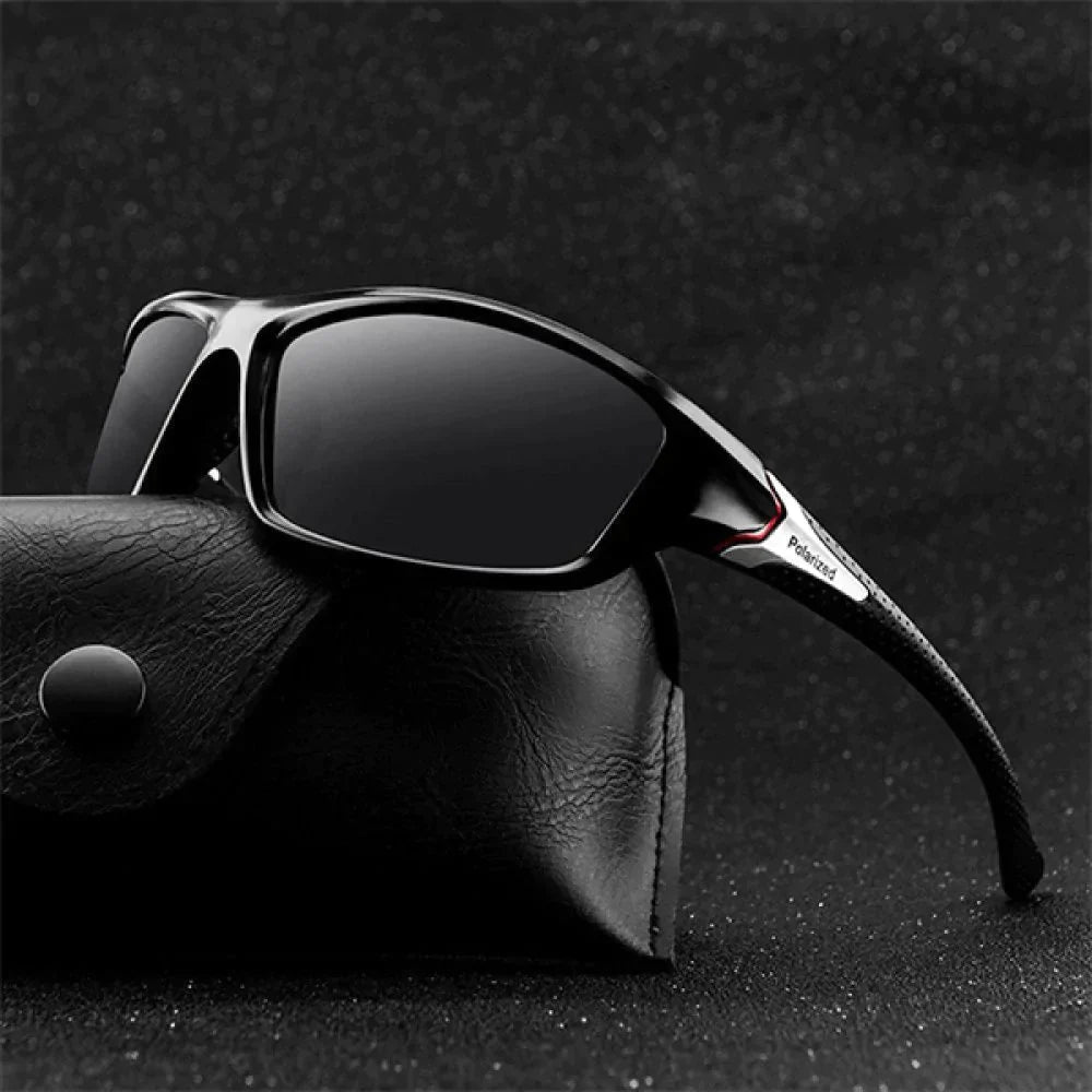 Óculos de sol esportivo polarizado preto com detalhe vermelho e proteção UV