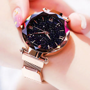 Relógio feminino rosa com mostrador estrelado e pulseira magnética.