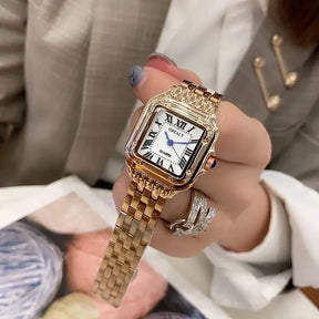 Relógio feminino dourado com mostrador romano e pulseira aço inox.