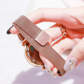 Relógio feminino rosa com mostrador estrelado e pulseira magnética.