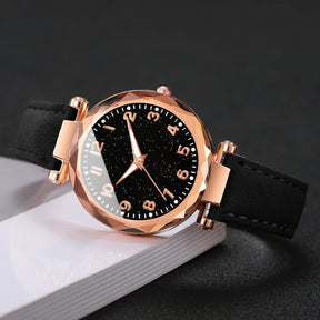 Relógio feminino céu estrelado preto com pulseiras douradas e pretas, elegante e moderno.