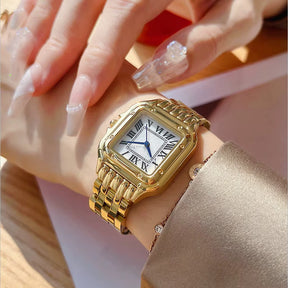 Relógio feminino dourado com mostrador romano e pulseira aço inox.